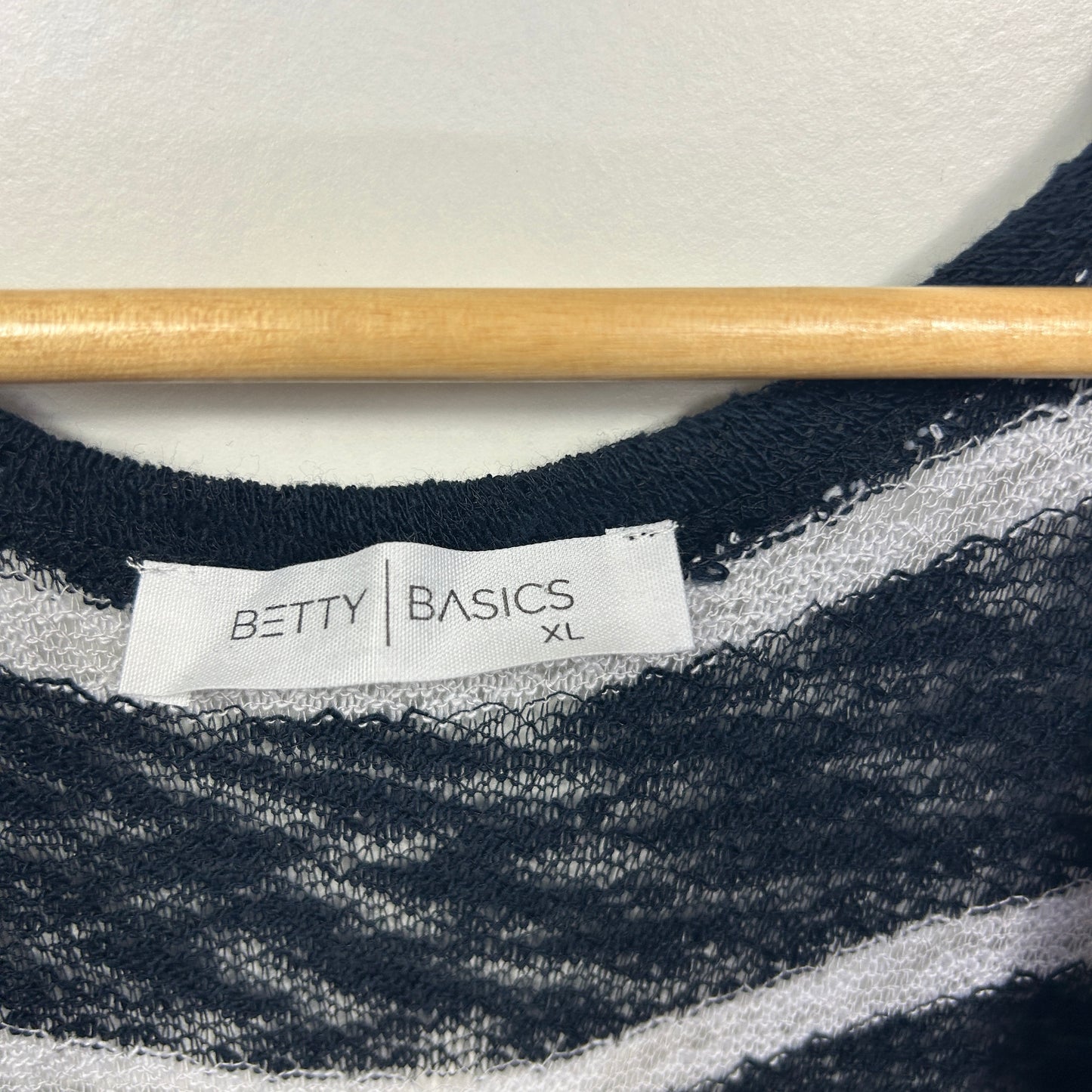 Black and white striped sweater label detail