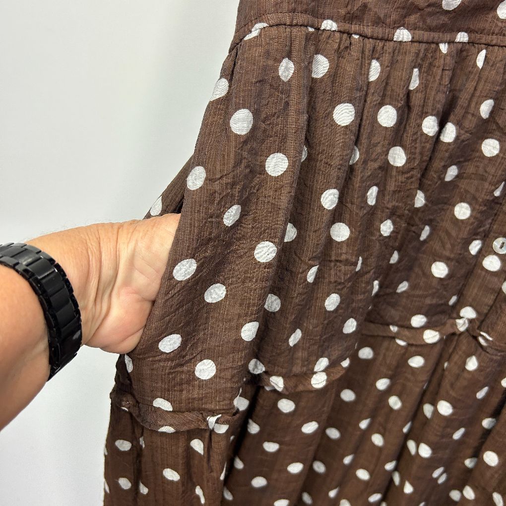 Brown and white polka dot shirt detail view