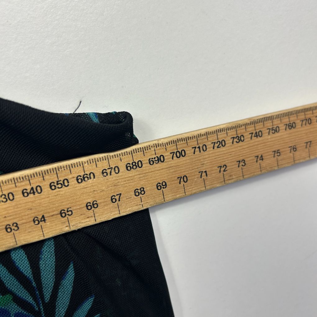 Black fabric with teal graphic detail measured with ruler