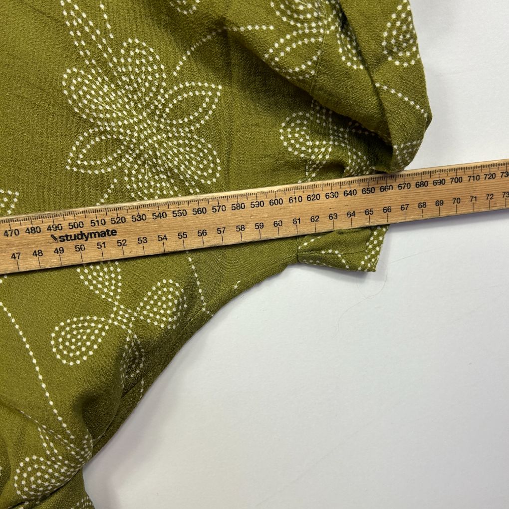 Green fabric with floral dotted pattern detail view