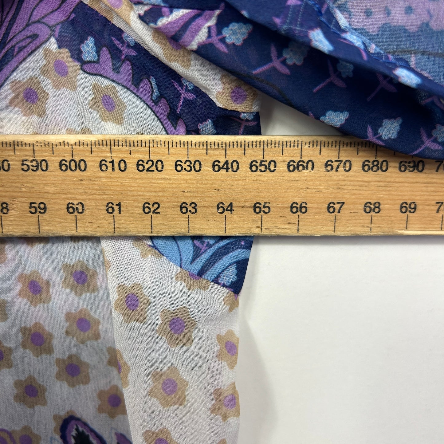 Purple and cream floral fabric detail view with measuring ruler