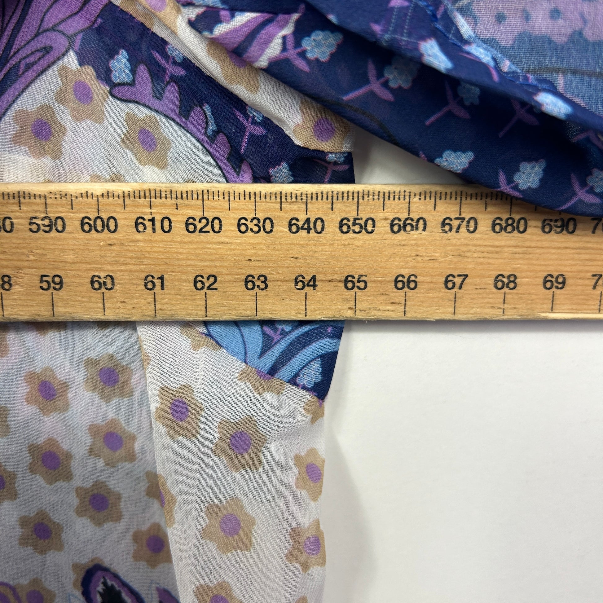 Purple and cream floral fabric detail view with measuring ruler