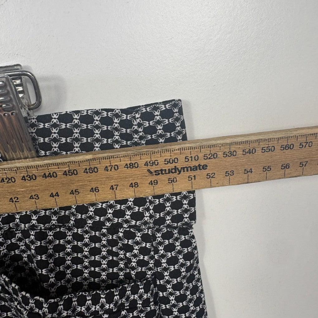 Black and white floral fabric detail view with measuring tape