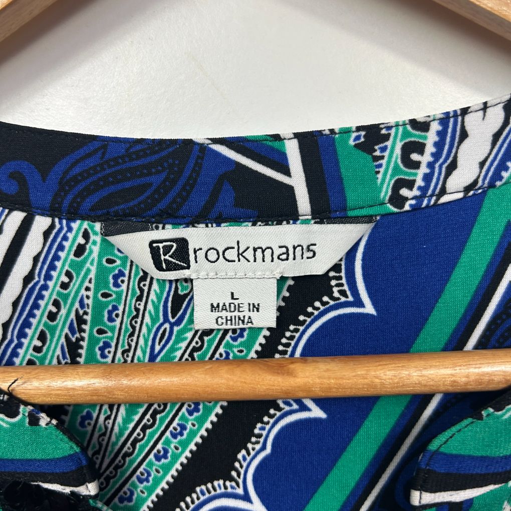 Blue and green geometric print fabric detail view with Rockmans label