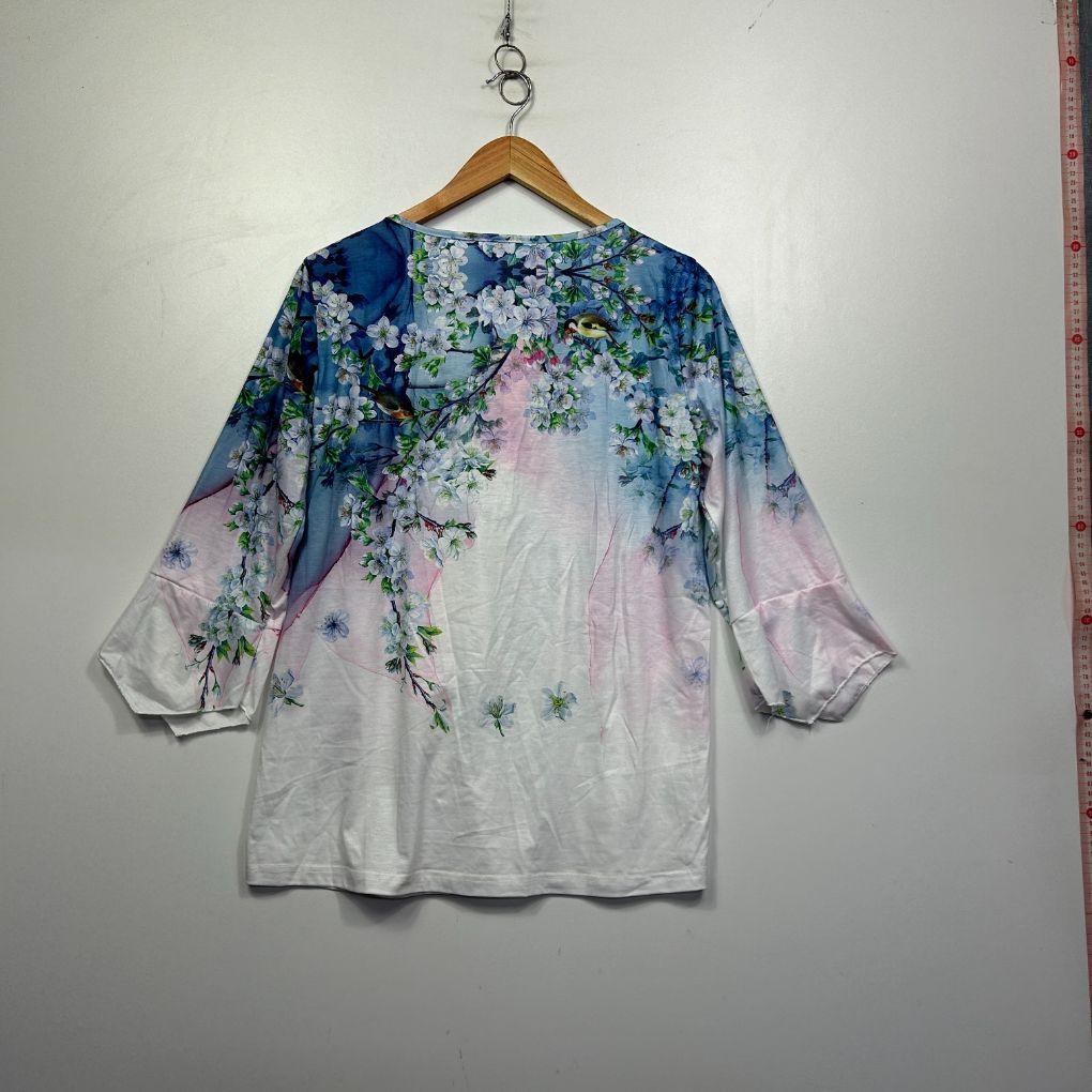 White tunic top with blue and purple floral print front view