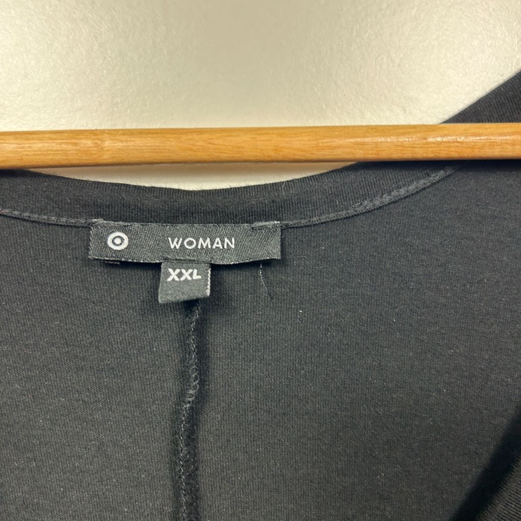 Black top label detail view showing Woman XXL size tag