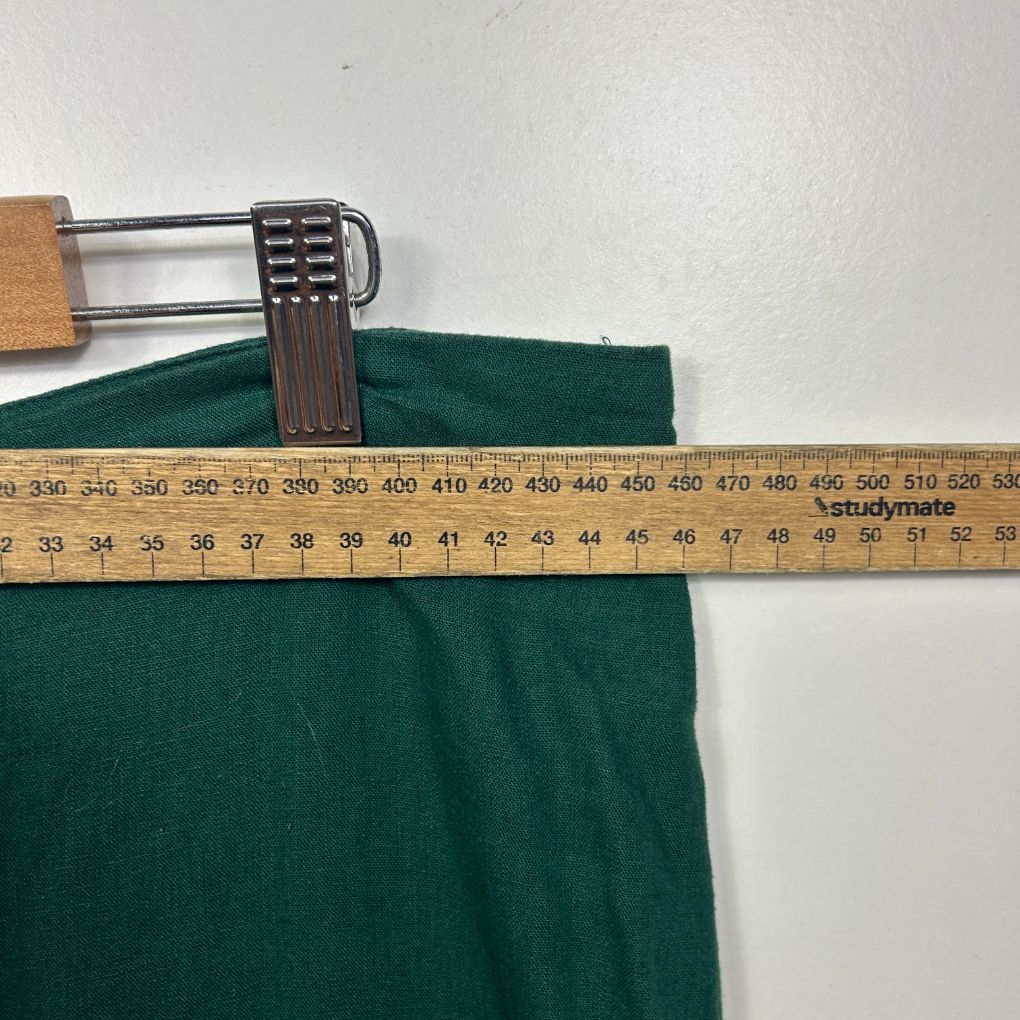 Green fabric with measuring tape detail view
