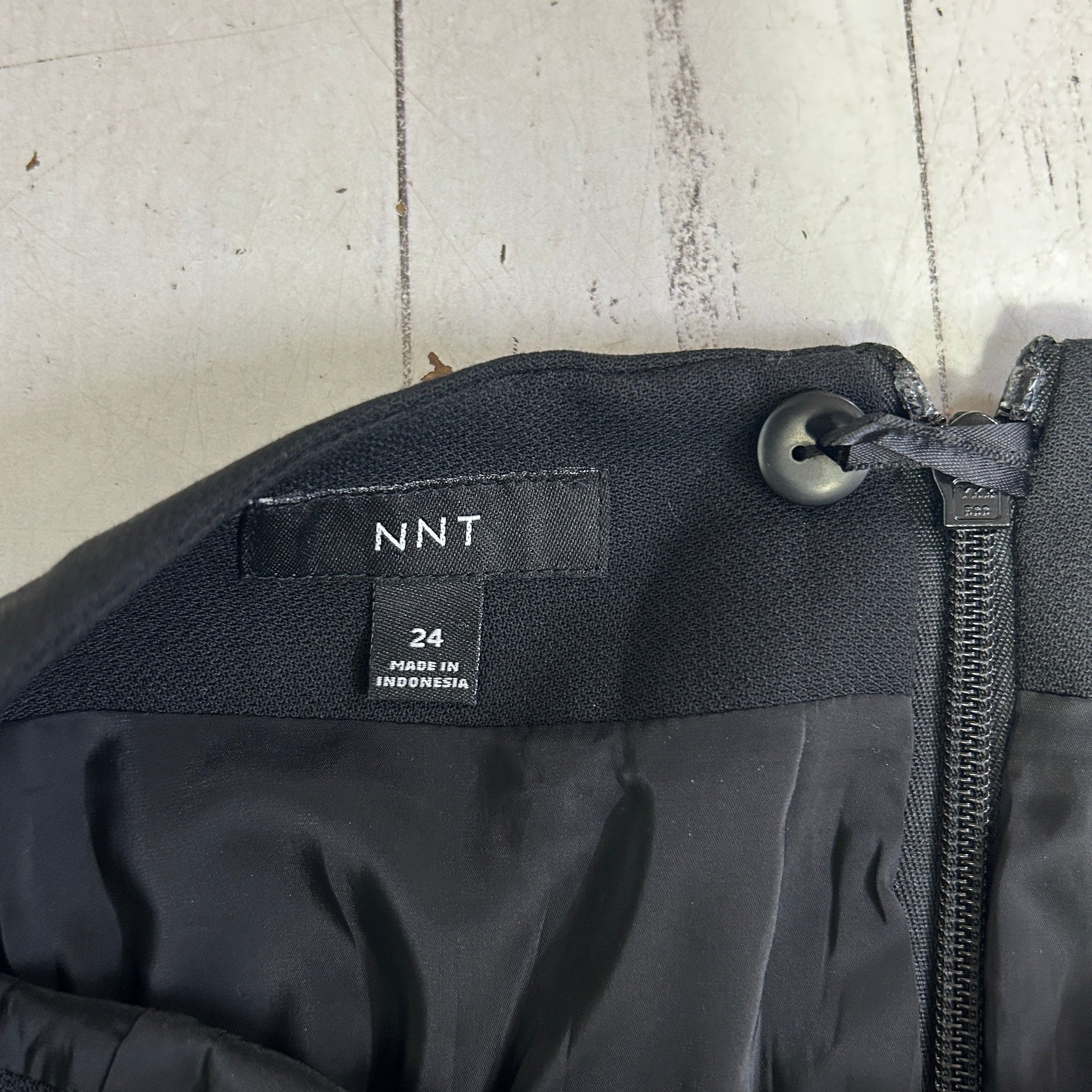 Black jacket detail view showing zipper and label