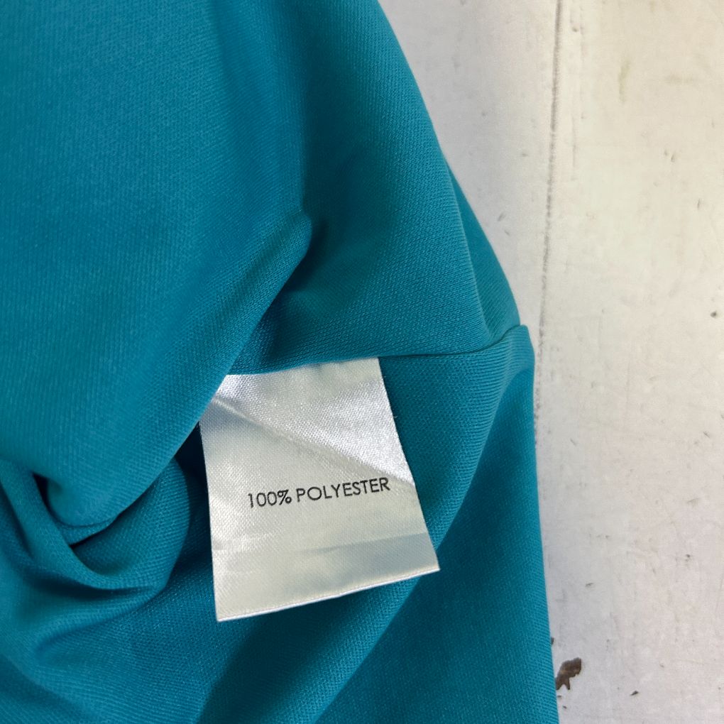 Teal polyester garment label detail view