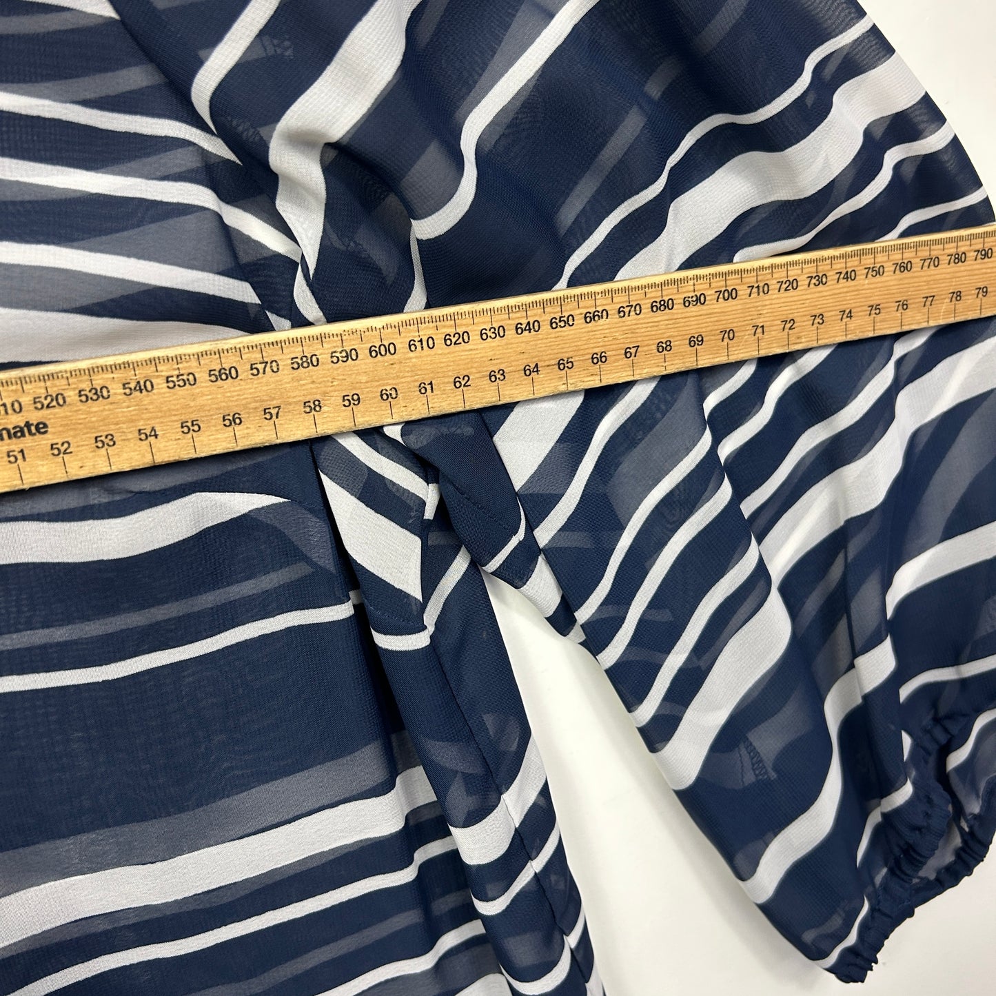 Navy and white striped fabric detail with measuring tape