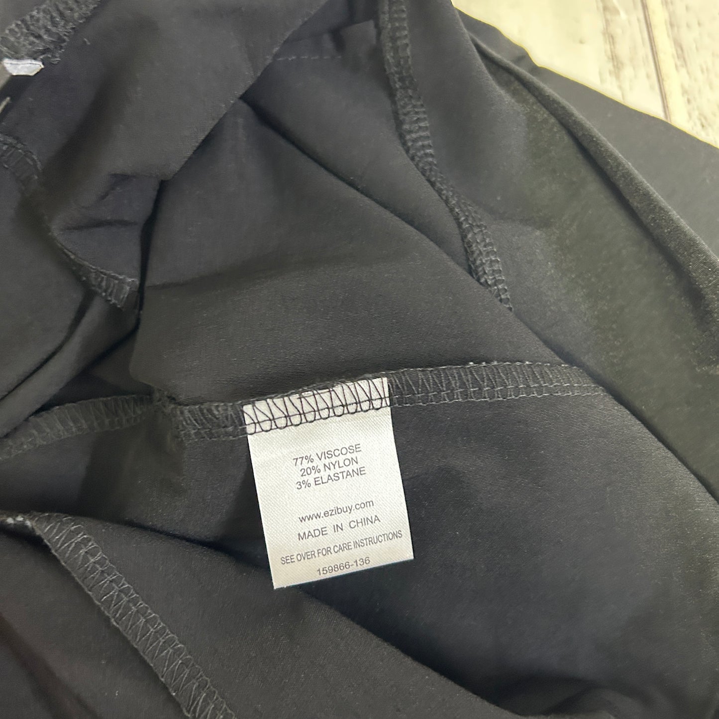 Black top detail view showing care label