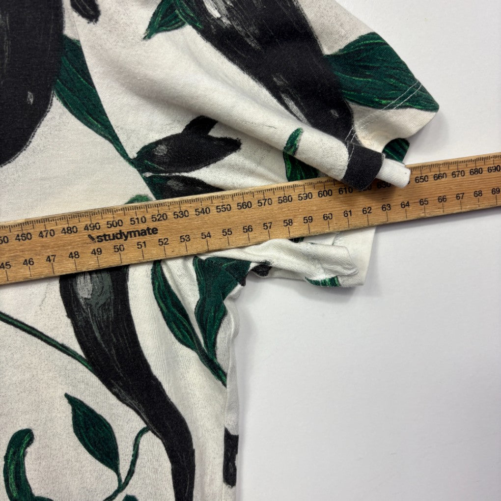 Cream and green graphic print top detail view with measuring tape