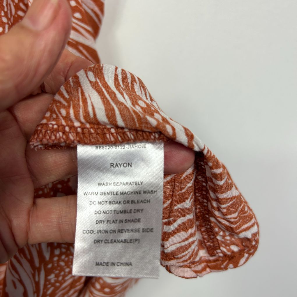 Rust and white zebra print top label detail view