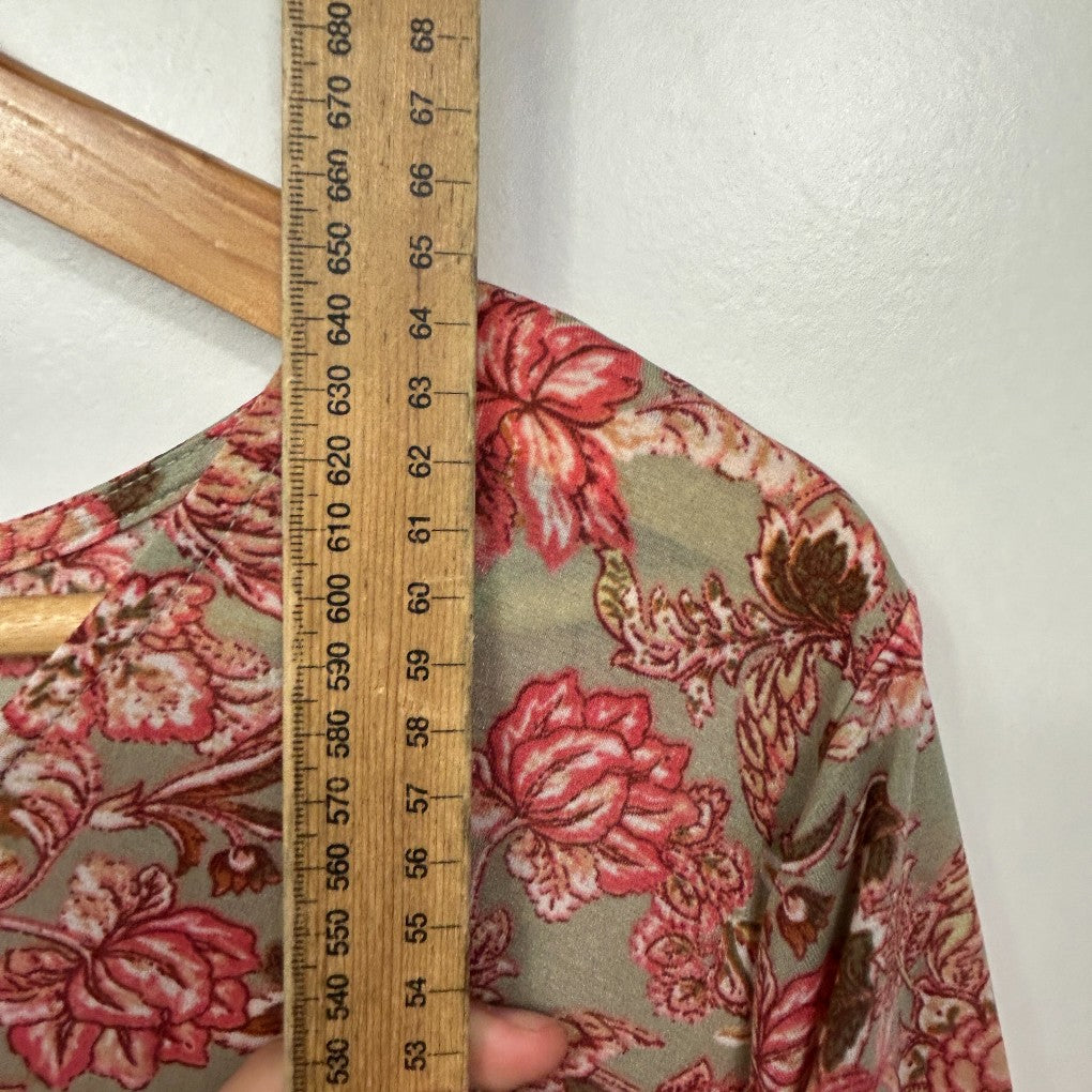 Red floral print shirt detail view with measuring tape