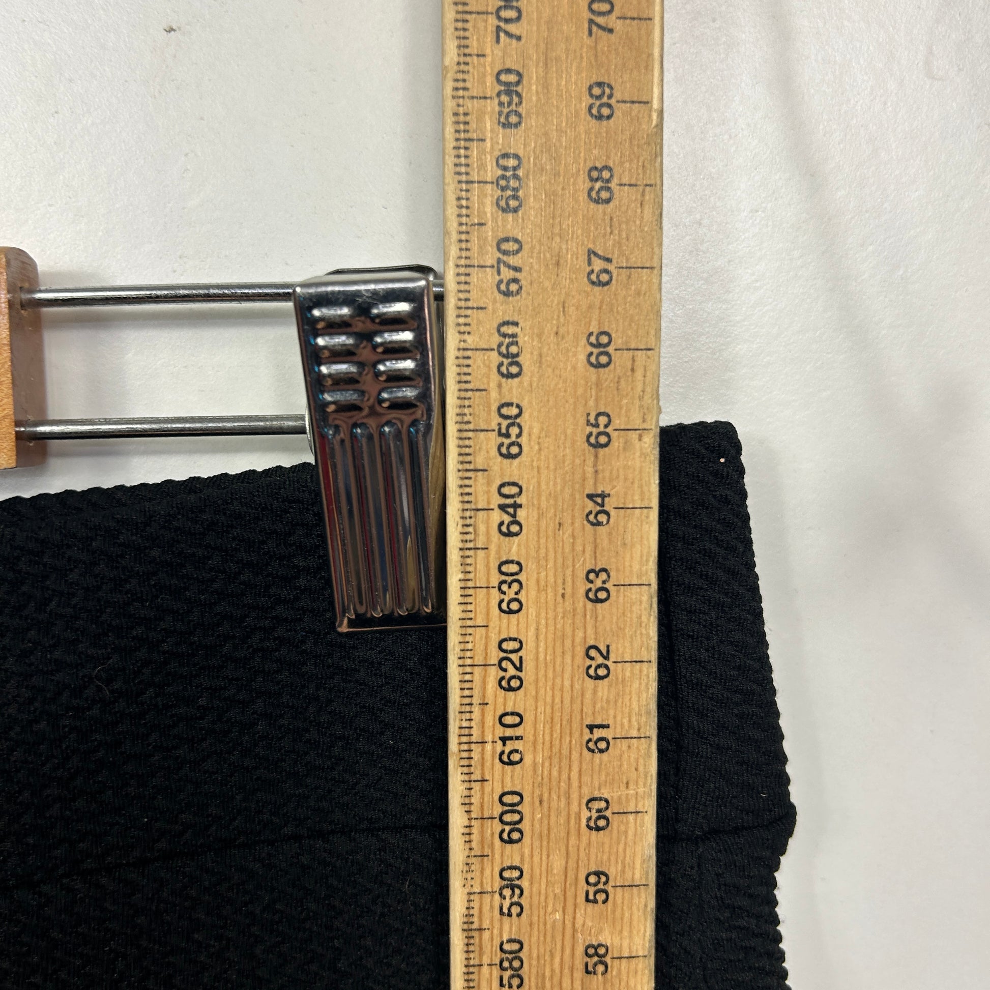 Black fabric detail view with measuring scale