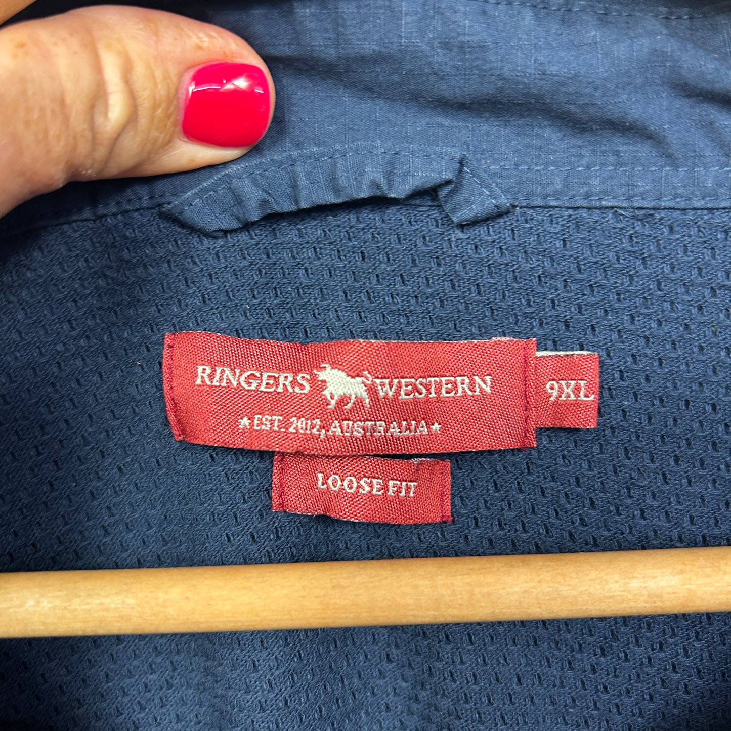 Navy blue shirt label detail view showing Ringers Western brand