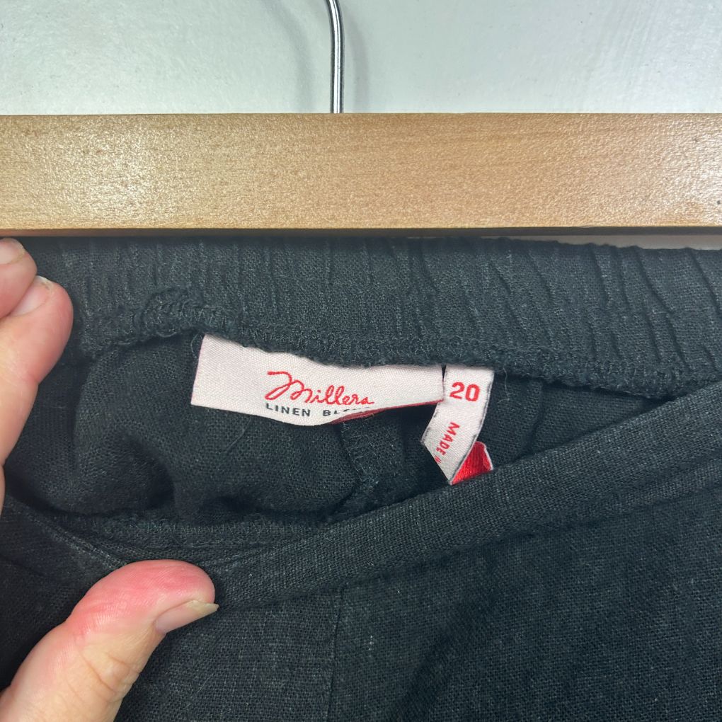 Black trousers label detail view