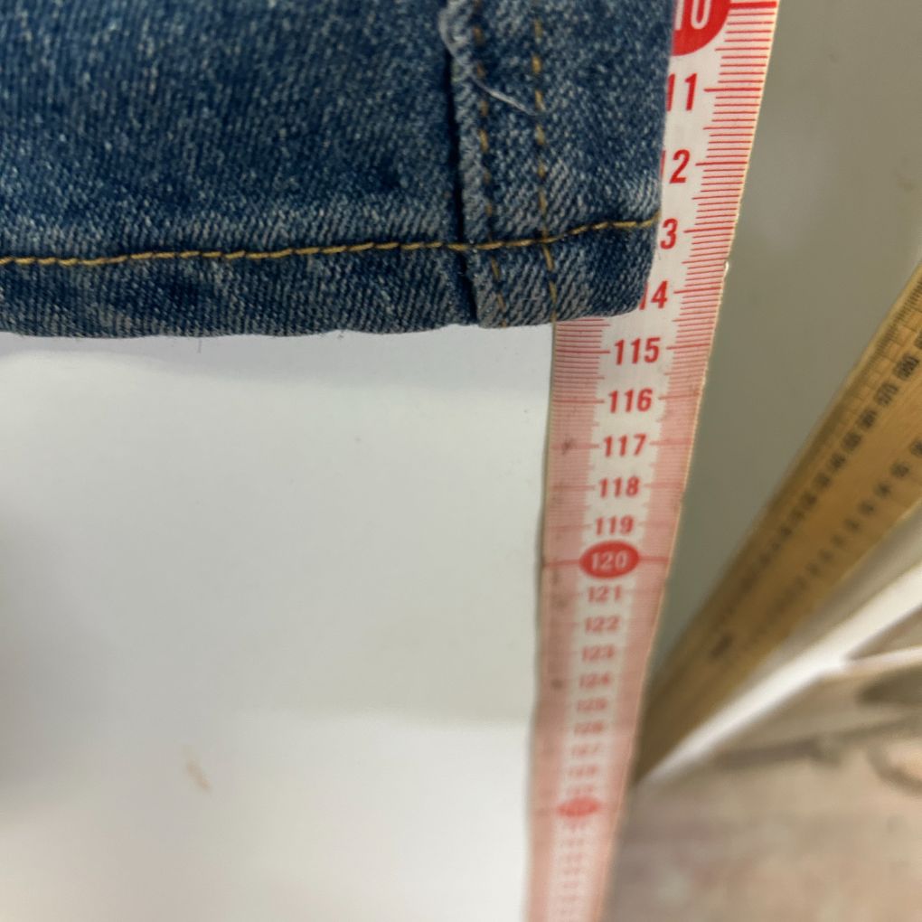 Blue denim and white fabric detail view with measuring tape