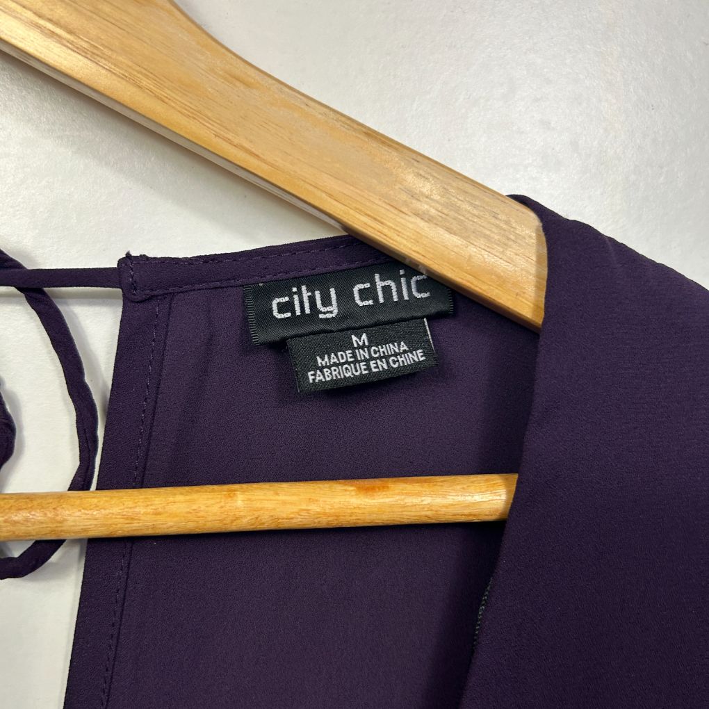 Navy blue sleeveless top front view on wooden hanger