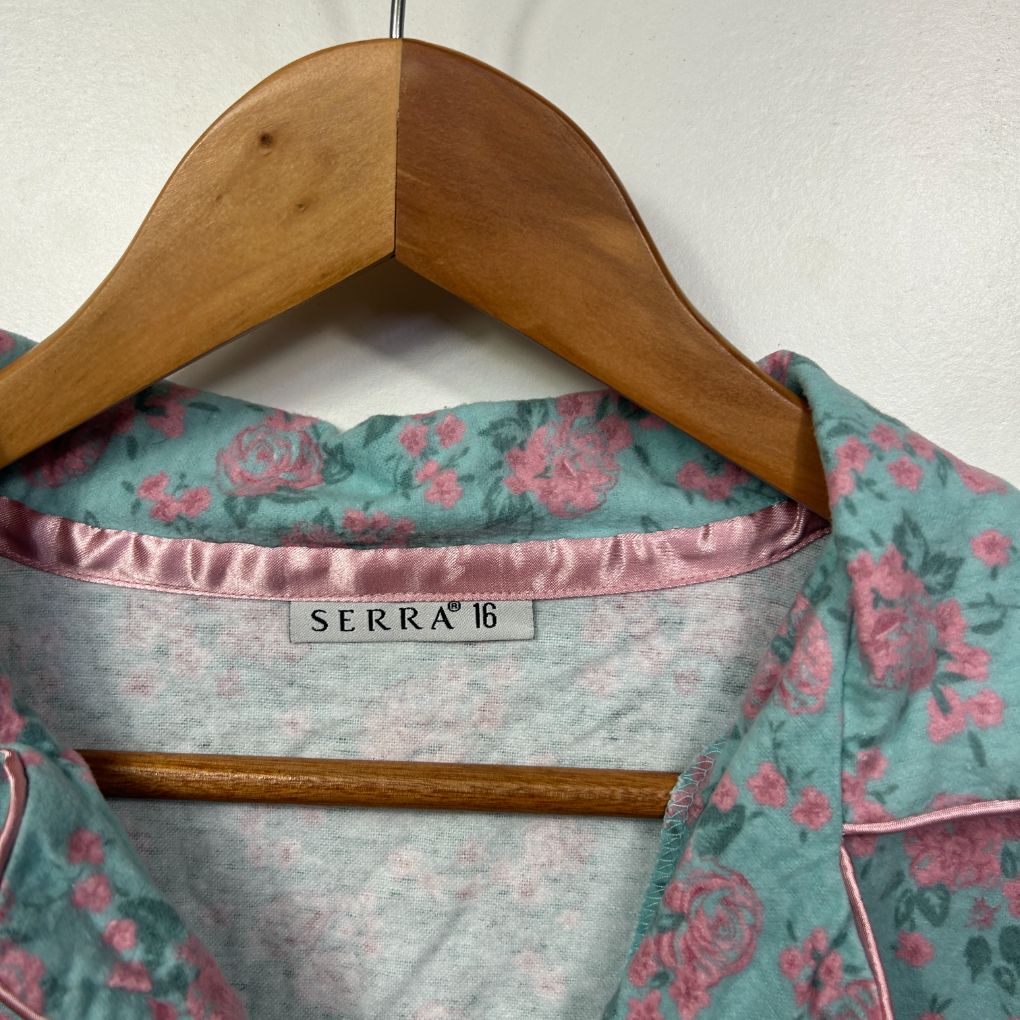Teal floral long sleeve top front view on wooden hanger