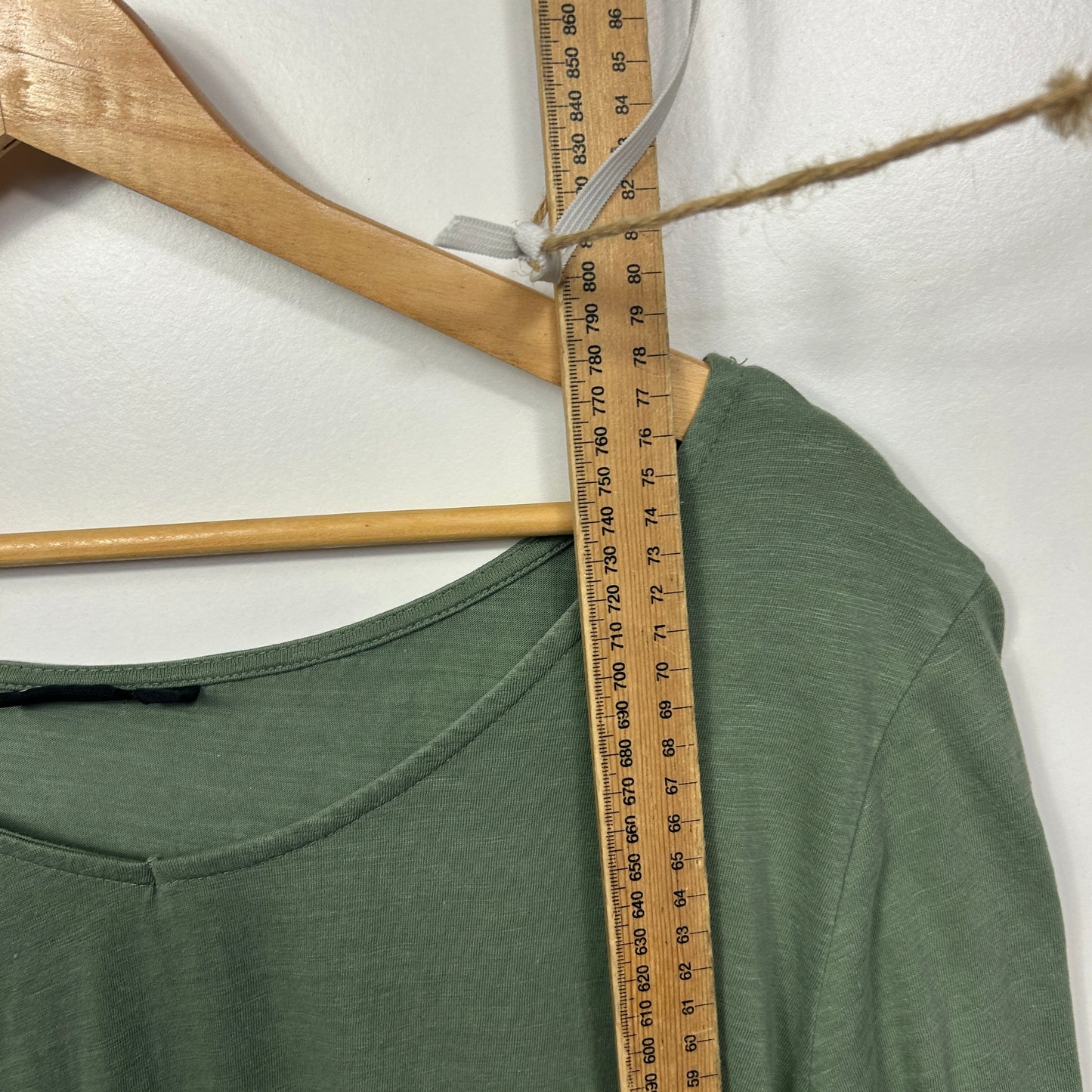 Green t-shirt front view with measuring tape