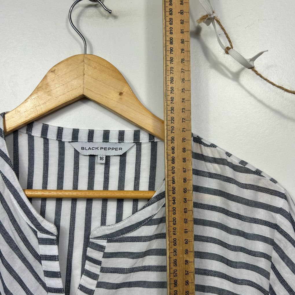 Navy and white striped shirt front view on wooden hanger