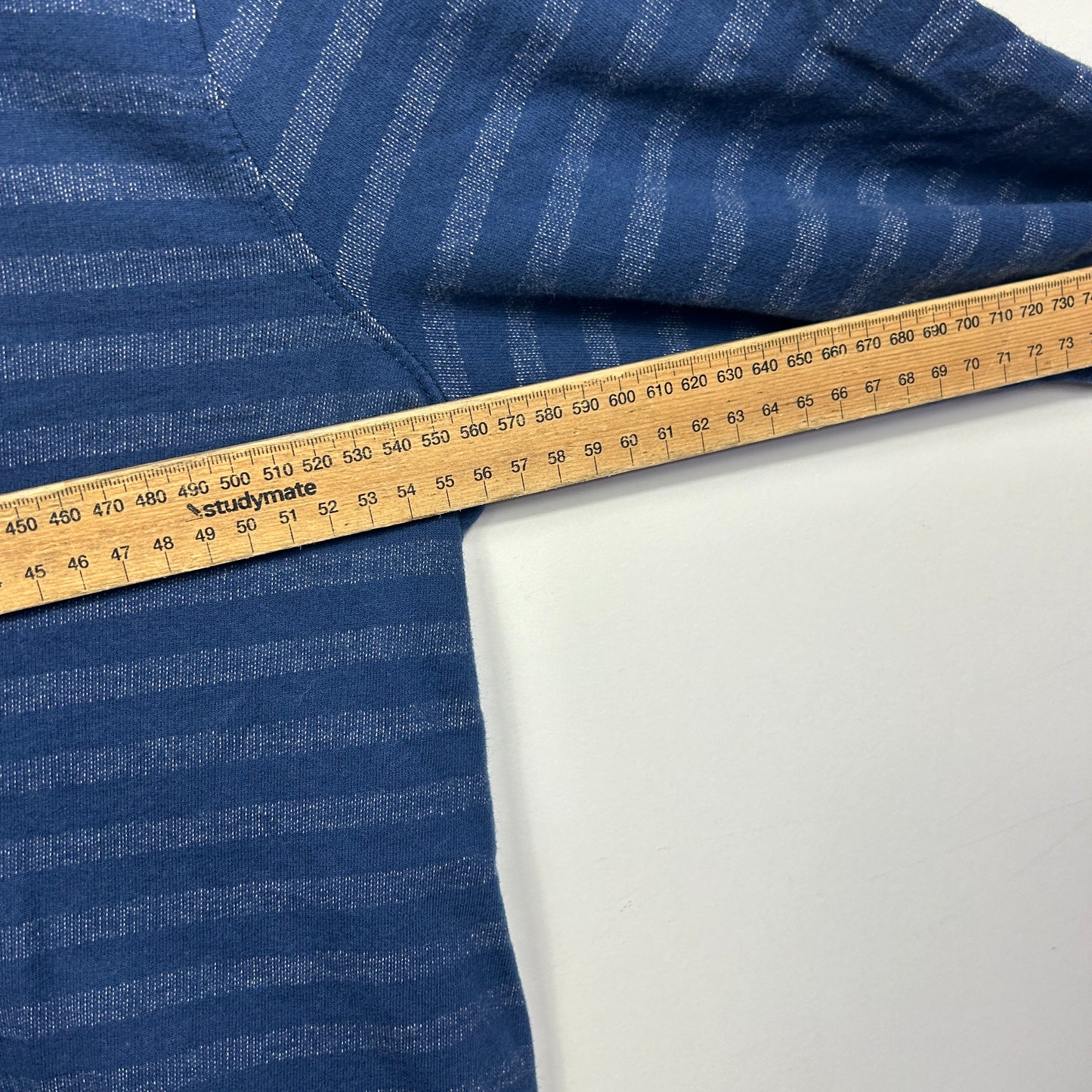 Navy striped fabric with measuring tape detail view