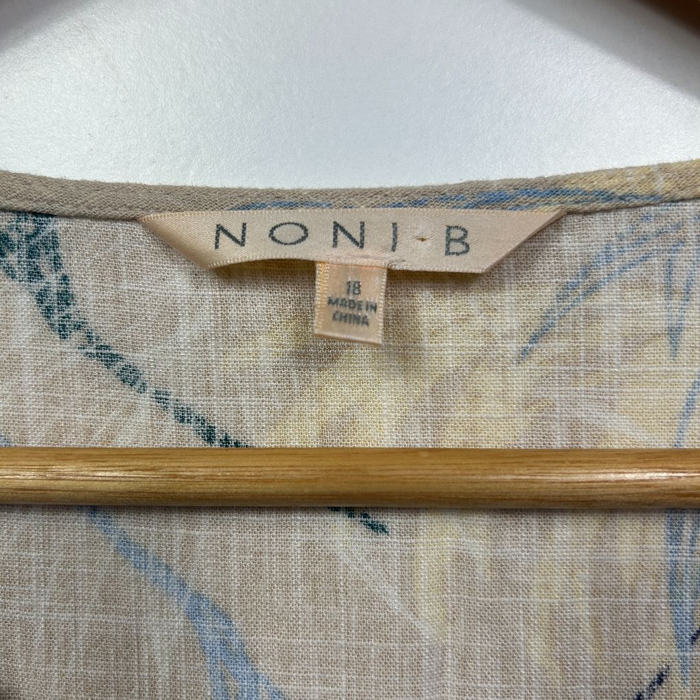 Beige linen top with blue striped detail label view