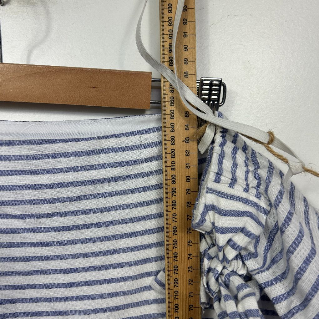 Blue and white striped fabric detail view with measuring tape