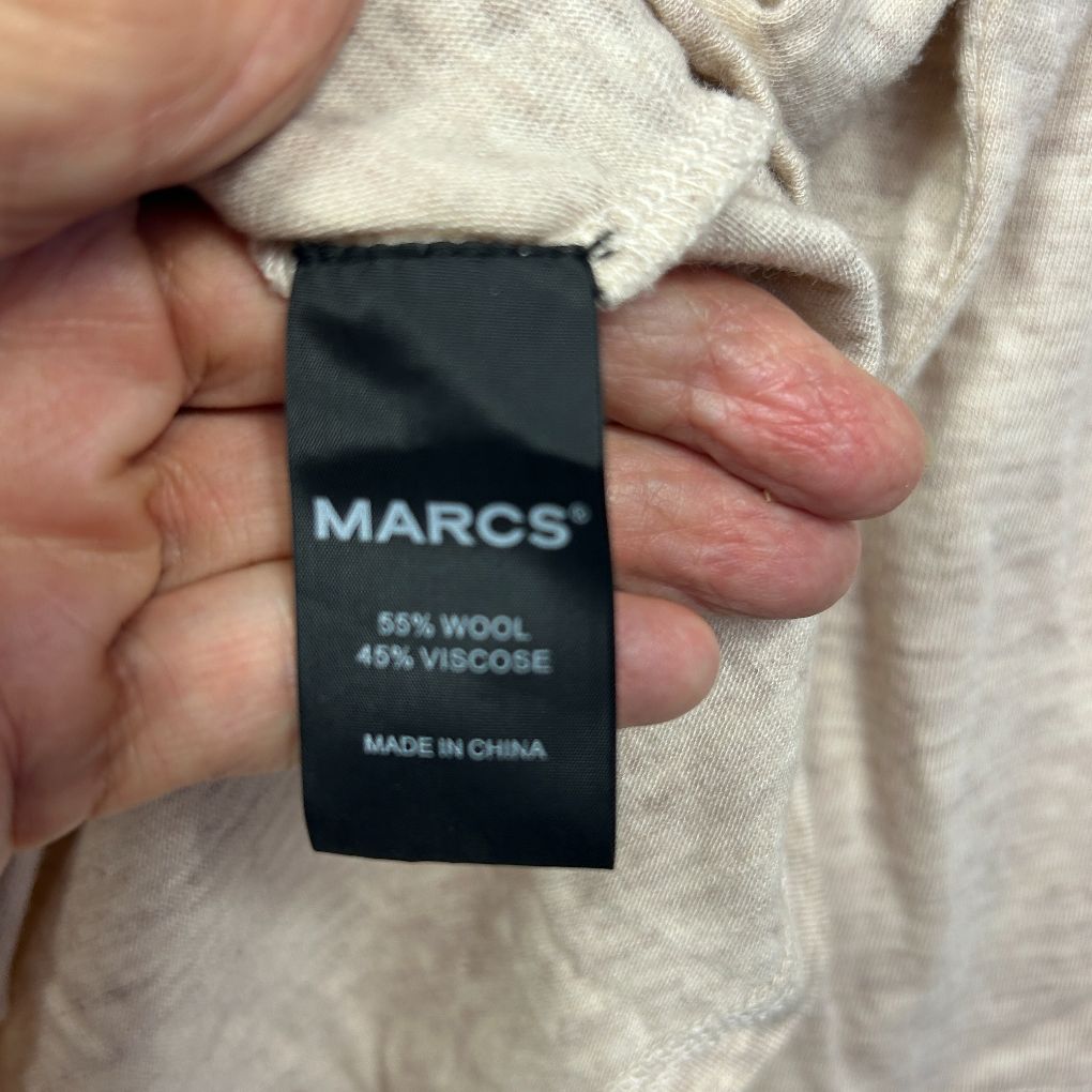 Cream knit garment label detail view