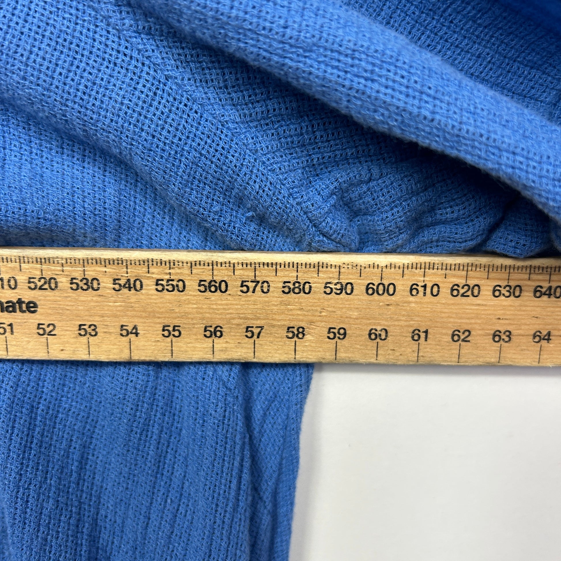 Blue fabric with measuring tape detail view