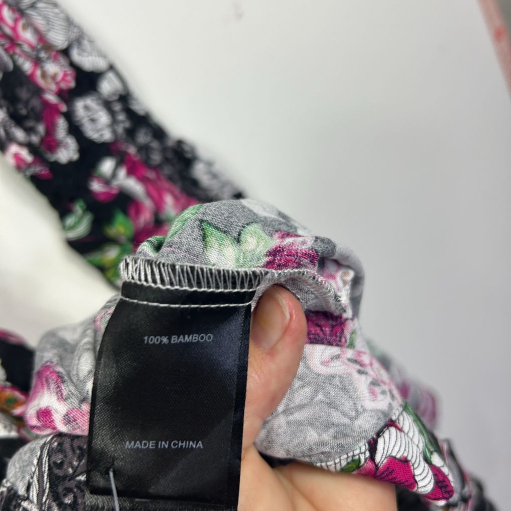 Floral cardigan detail view showing bamboo fabric label