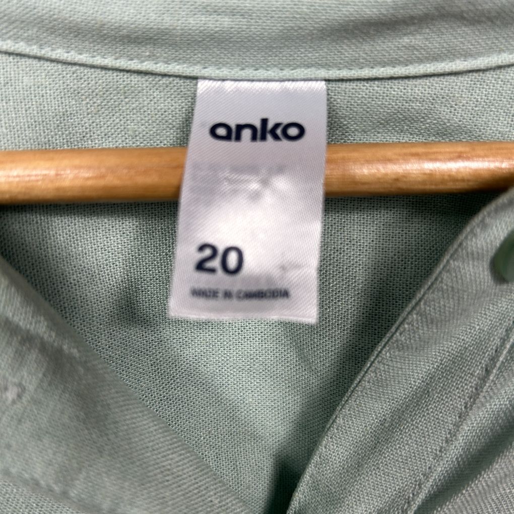 Sage green long sleeve top label detail view