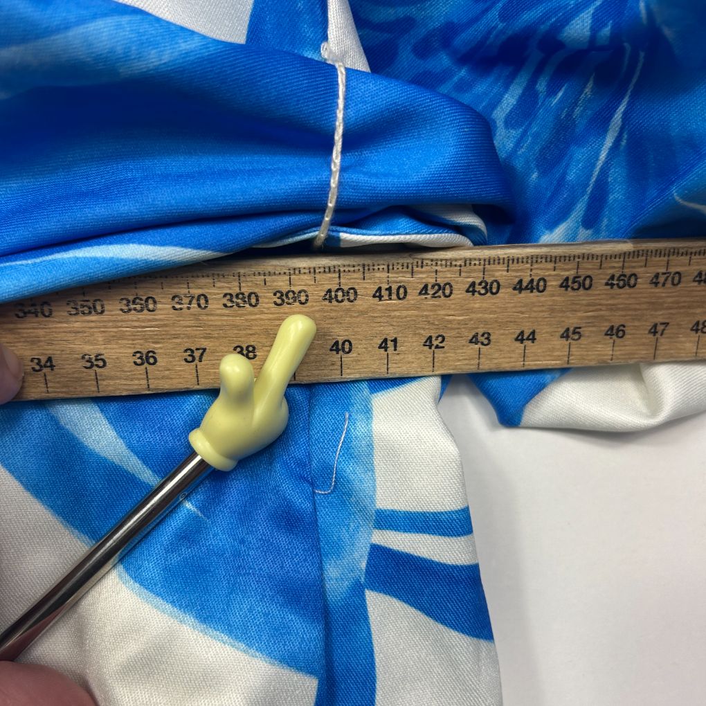 Blue and white striped fabric detail view with measuring tape