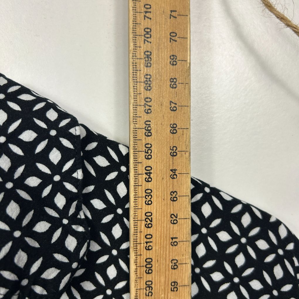 Black and white geometric pattern fabric detail view with measuring ruler