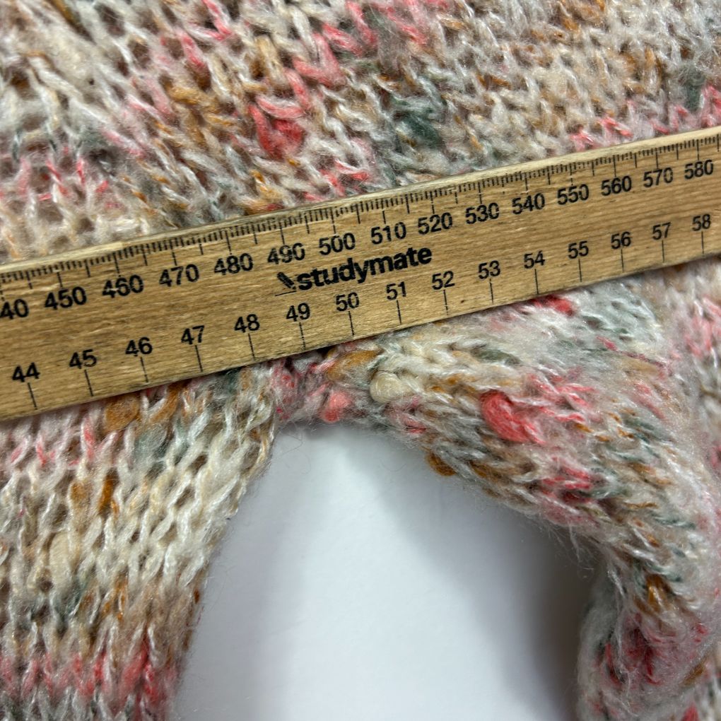 Multicoloured knit texture detail view with measuring tape