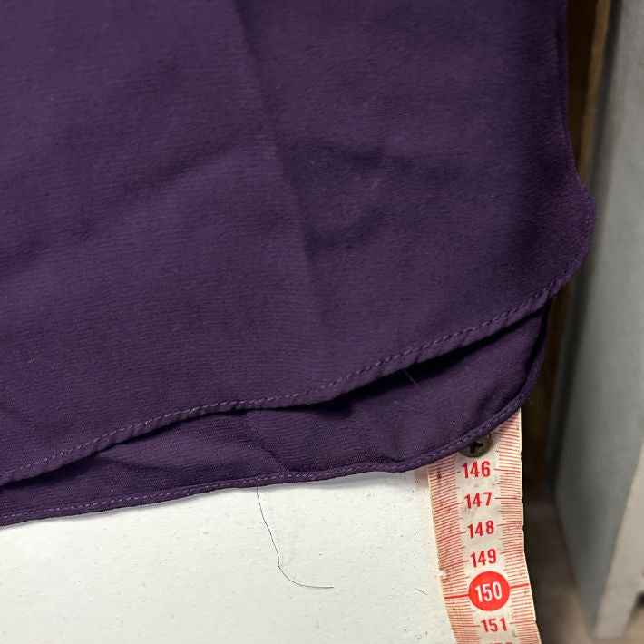 Purple and white two-tone garment with size label detail view