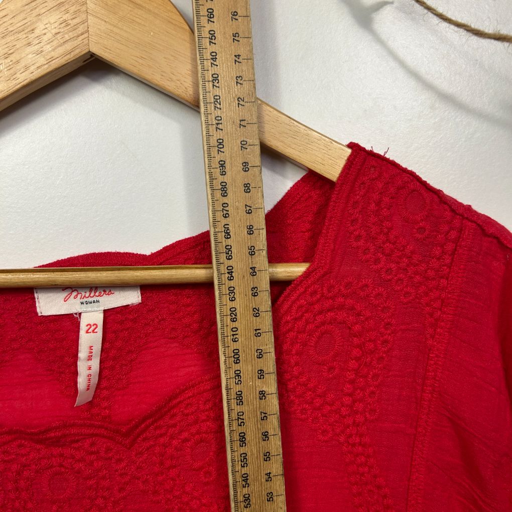 Red knit sweater front view with size label