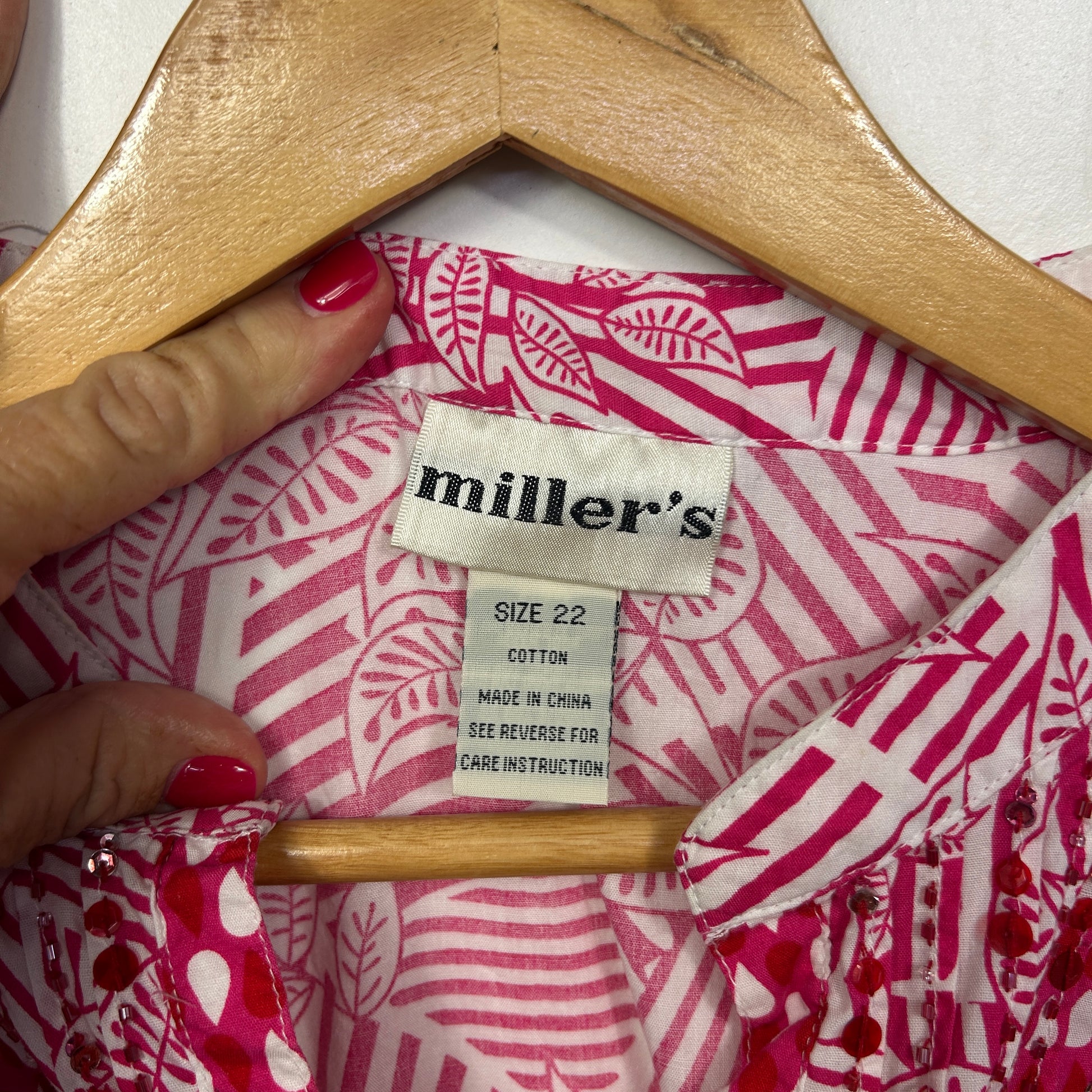 Pink and white striped shirt label detail view