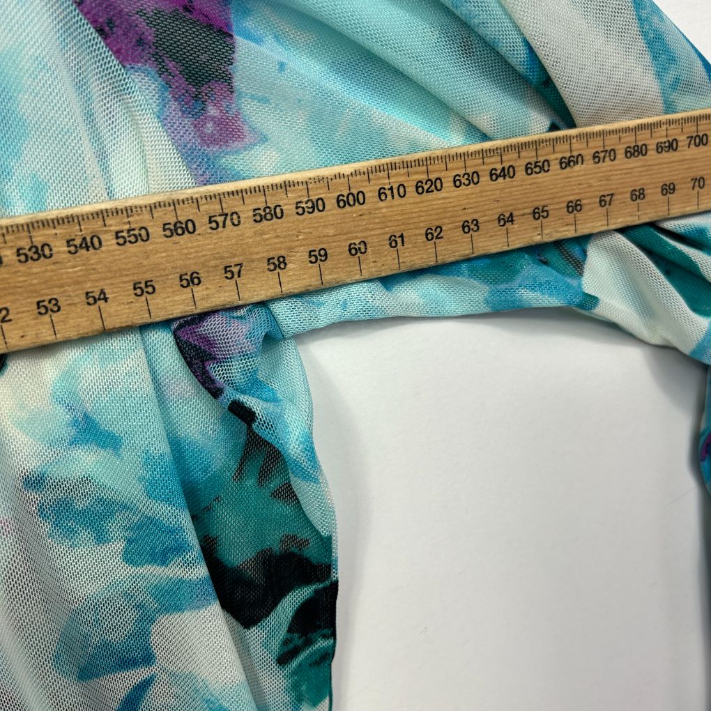 Blue floral fabric detail view with measuring tape