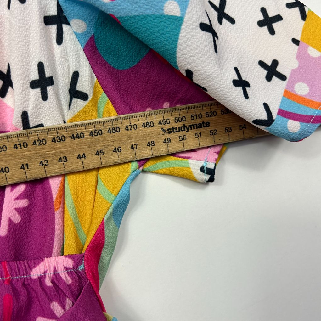 Colorful fabric with cross pattern and measuring tape detail view