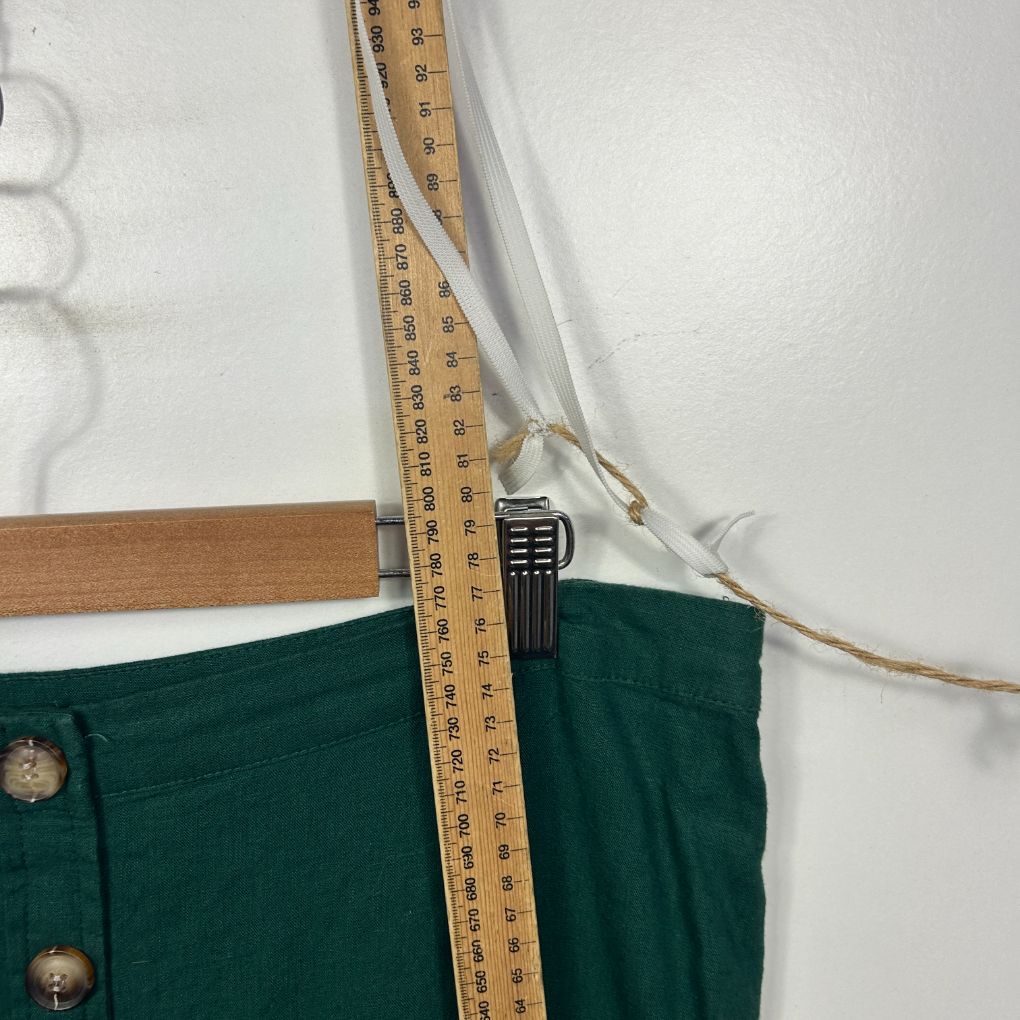 Green shorts front view with measurement detail