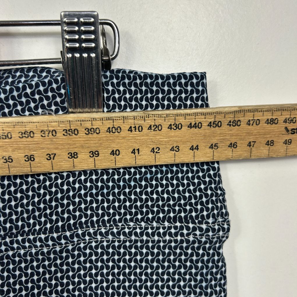Navy and white geometric patterned shorts with measuring tape detail view