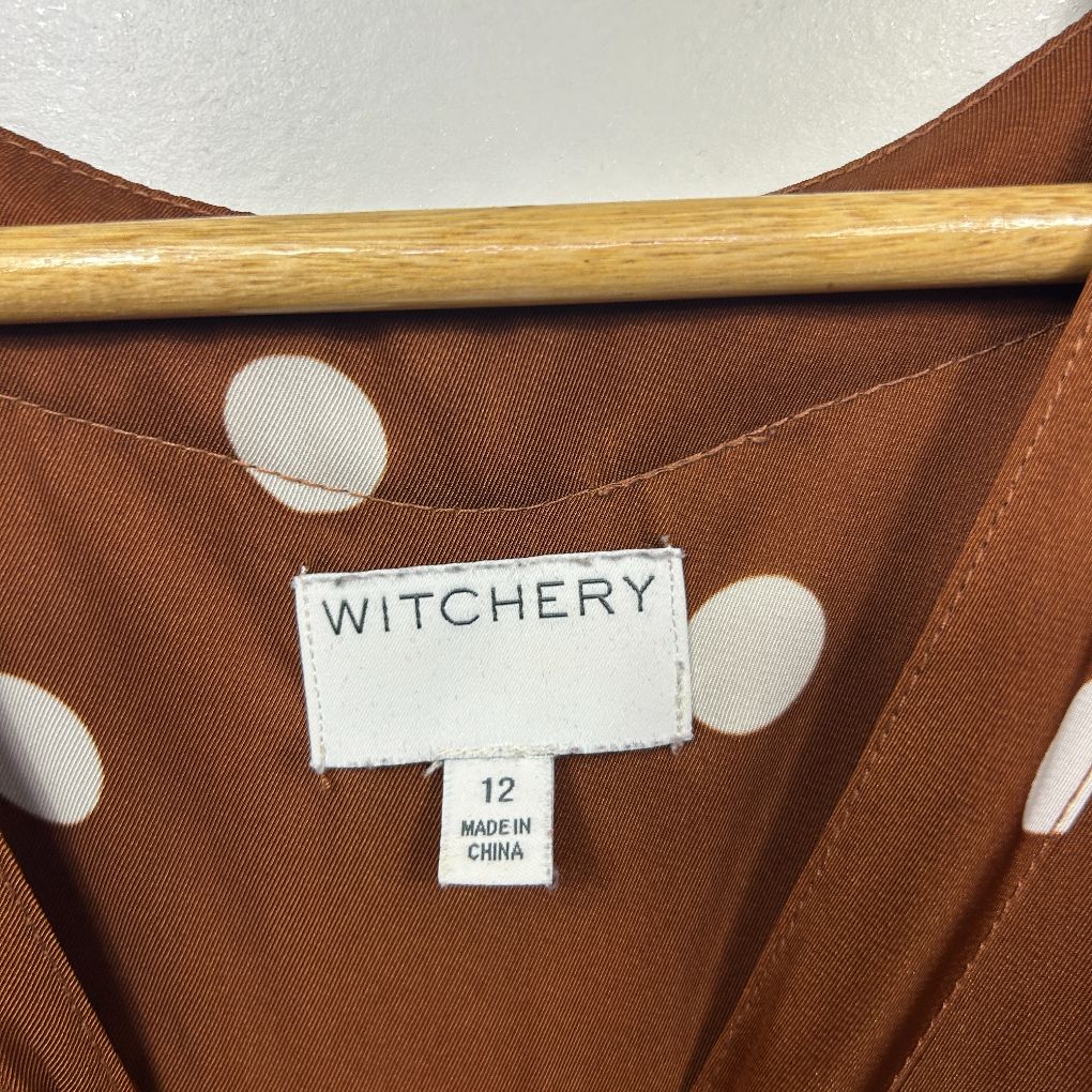 Brown polka dot blouse label view