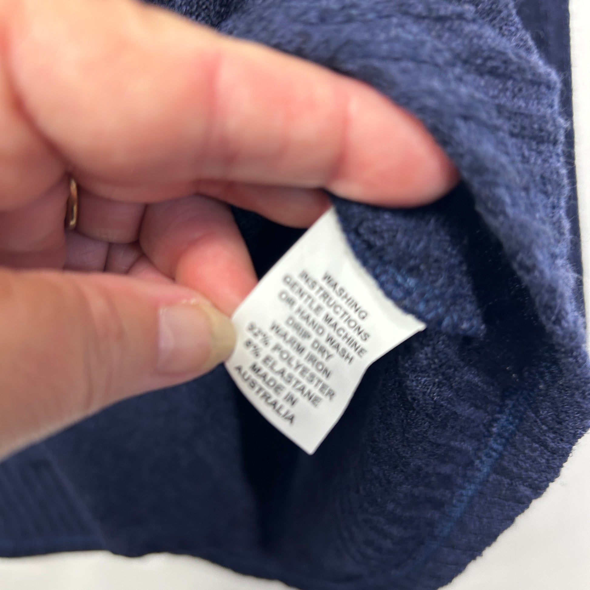 Navy blue garment care label detail view