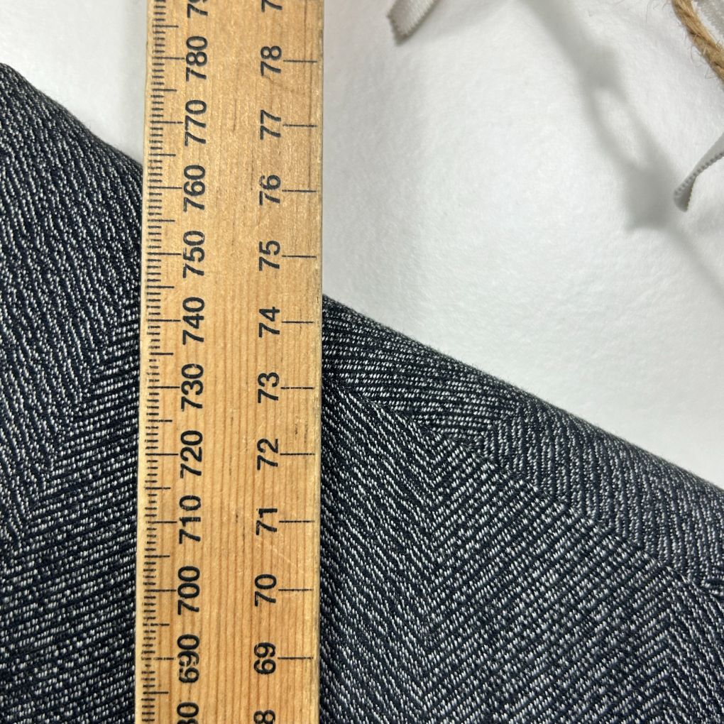Grey herringbone fabric detail view with measuring ruler