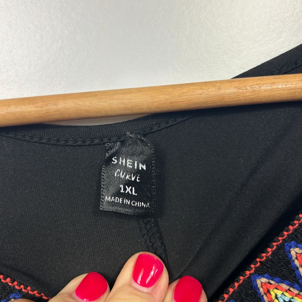 Black top label detail view showing SHEIN curve size XL tag