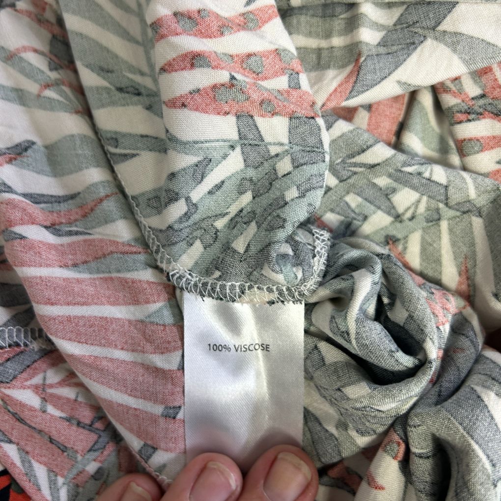 Red and grey striped scarf detail view showing fabric label