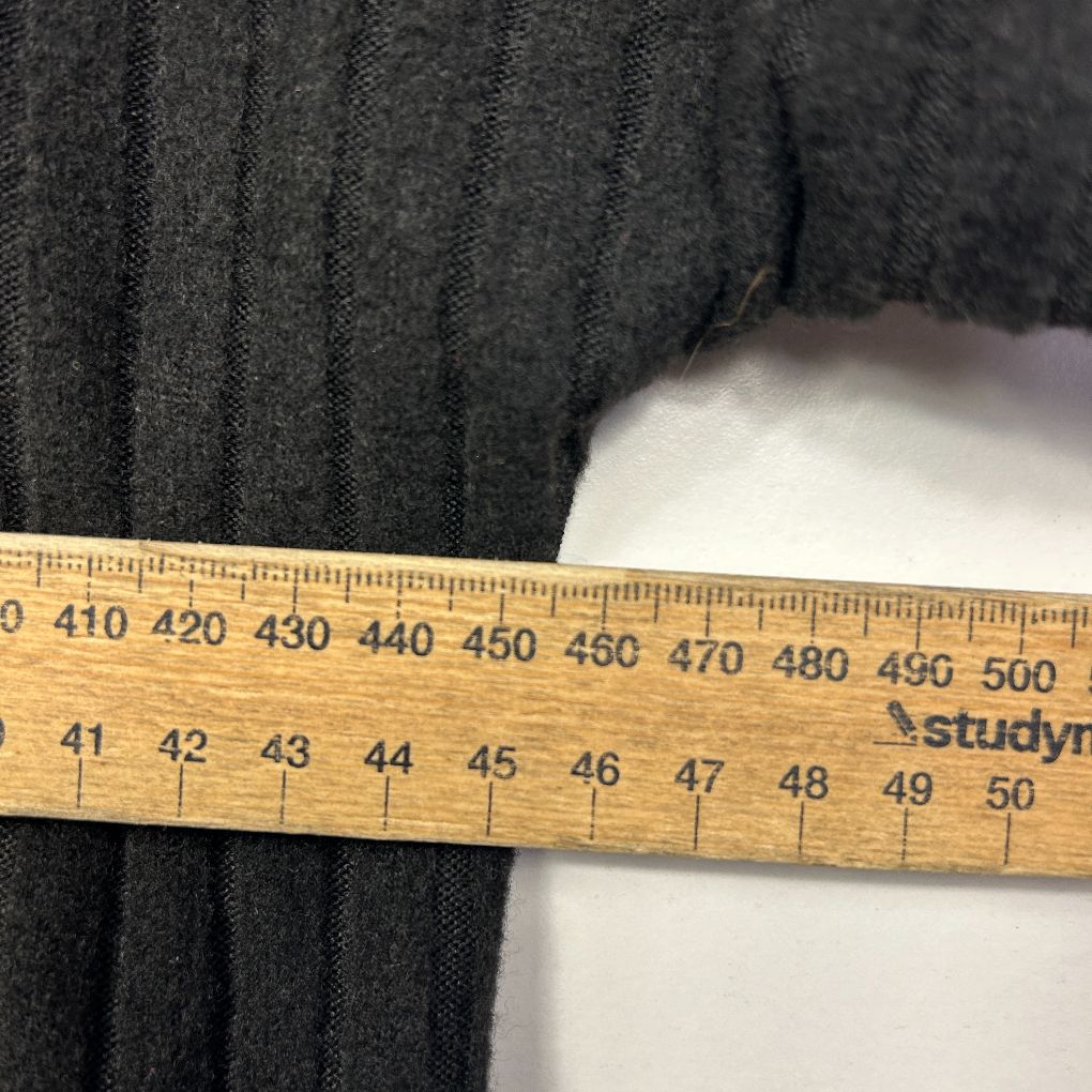 Dark grey striped fabric detail with measuring ruler