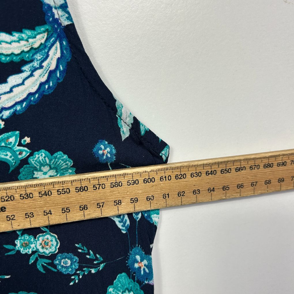 Navy floral dress detail view with measuring tape